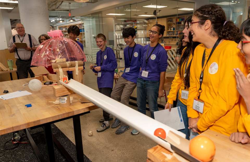 2025 Thermo Fisher purple team and gold team are all smiles seeing the contraption kick start.