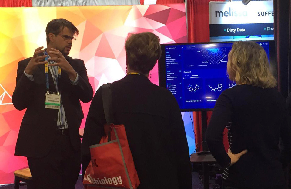 Notable Alumni Christopher Bouton (left) presenting on AI at Bio-IT World 2018.