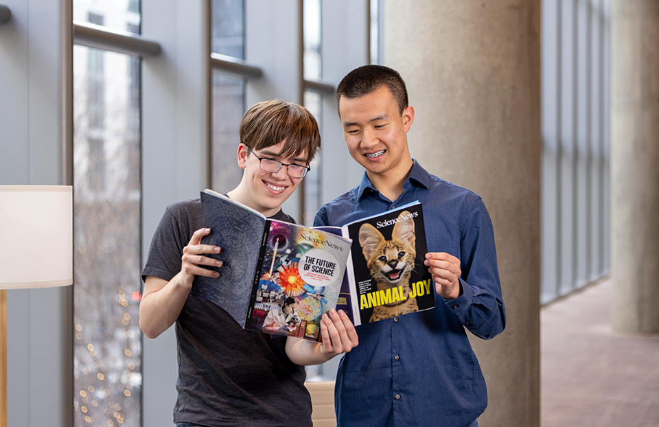 Regeneron STS 2026 finalists Connor Hill and Henry Xie with the Science News issues from December 2025 and February 2026.