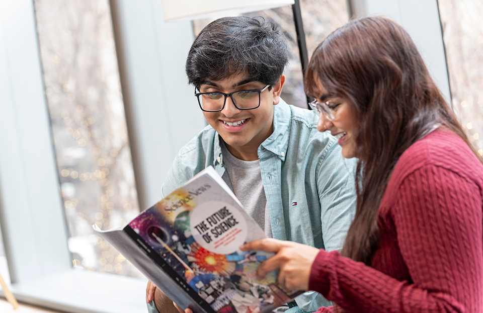 STS 2026 finalists Rohan Arni and Ryka Chopra reading the December 2025 issue of Science News.