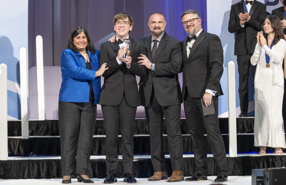 Connor Hill on the awards stage after winning first place at Regeneron STS 