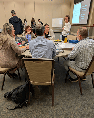 North Carolina STEM Research Fellows discussing with each other.