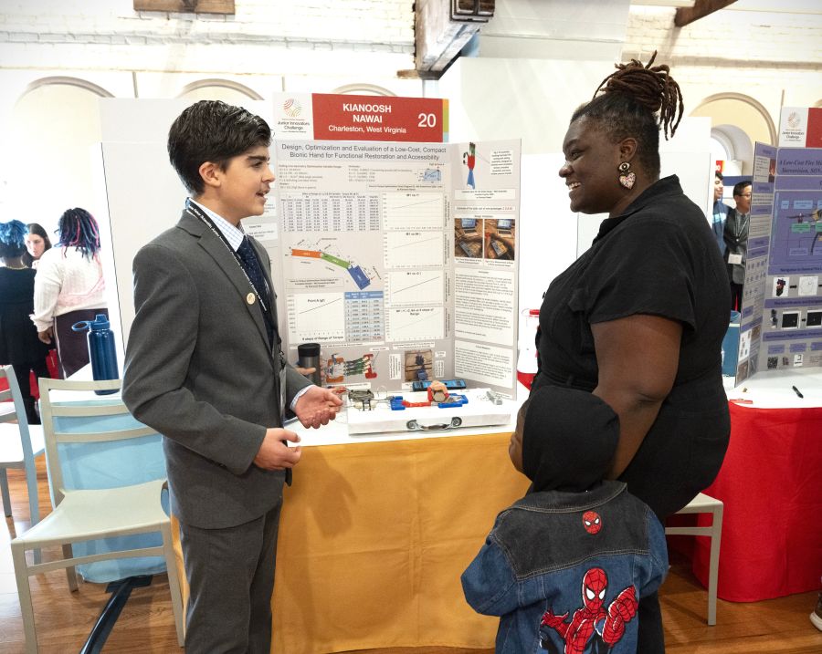 Finalist Kianoosh Nawai explains his bionic hand project to visitors at the 2026 Thermo Fisher JIC Public Exhibition of Projects.